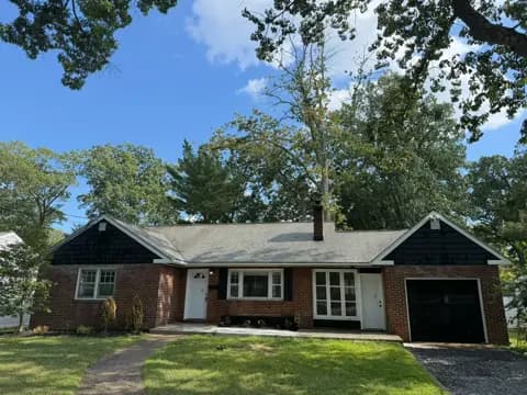 Brick ranch house after washing, with a clean roof and exterior