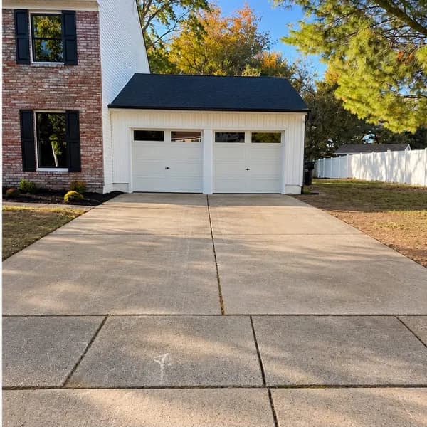 Clean driveway after pressure washing, with a brighter concrete surface