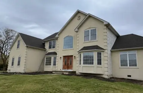 House exterior after washing, with clean light siding